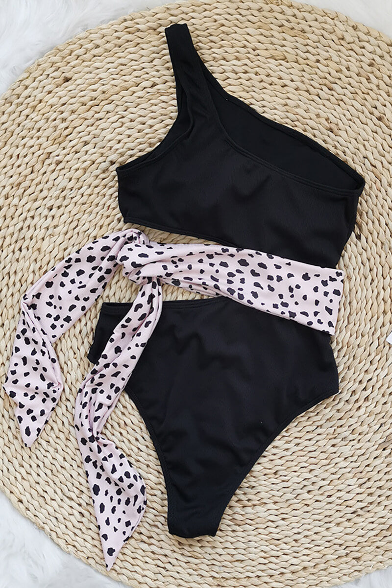 Blue one shoulder one piece swimsuit with pink waist tie and side cutout flat lay