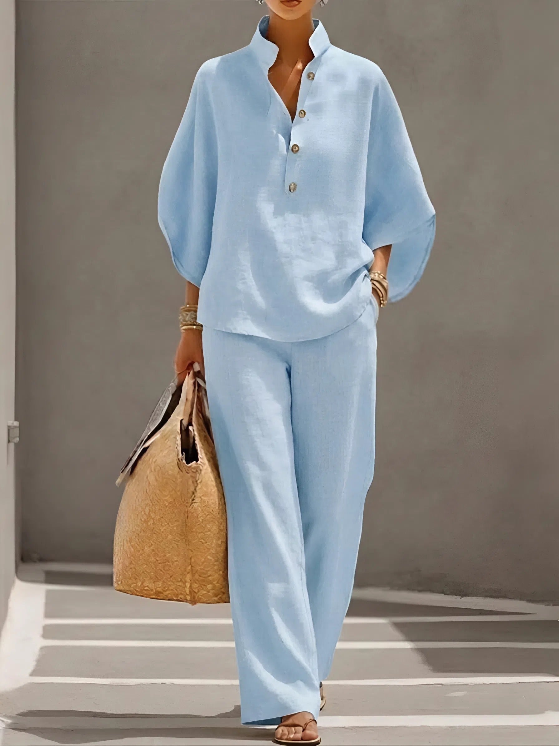 Light blue two piece set featuring half button shirt top and wide leg linen pants