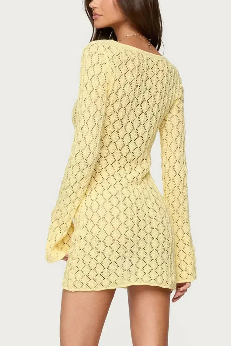Back view of yellow crochet mini dress with open-knit pattern and long sleeves