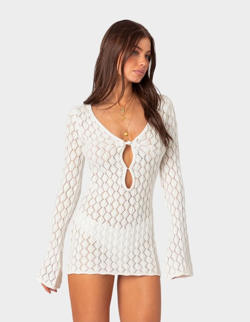 Front view of white summer crochet mini dress with tie front and flared sleeve cuffs