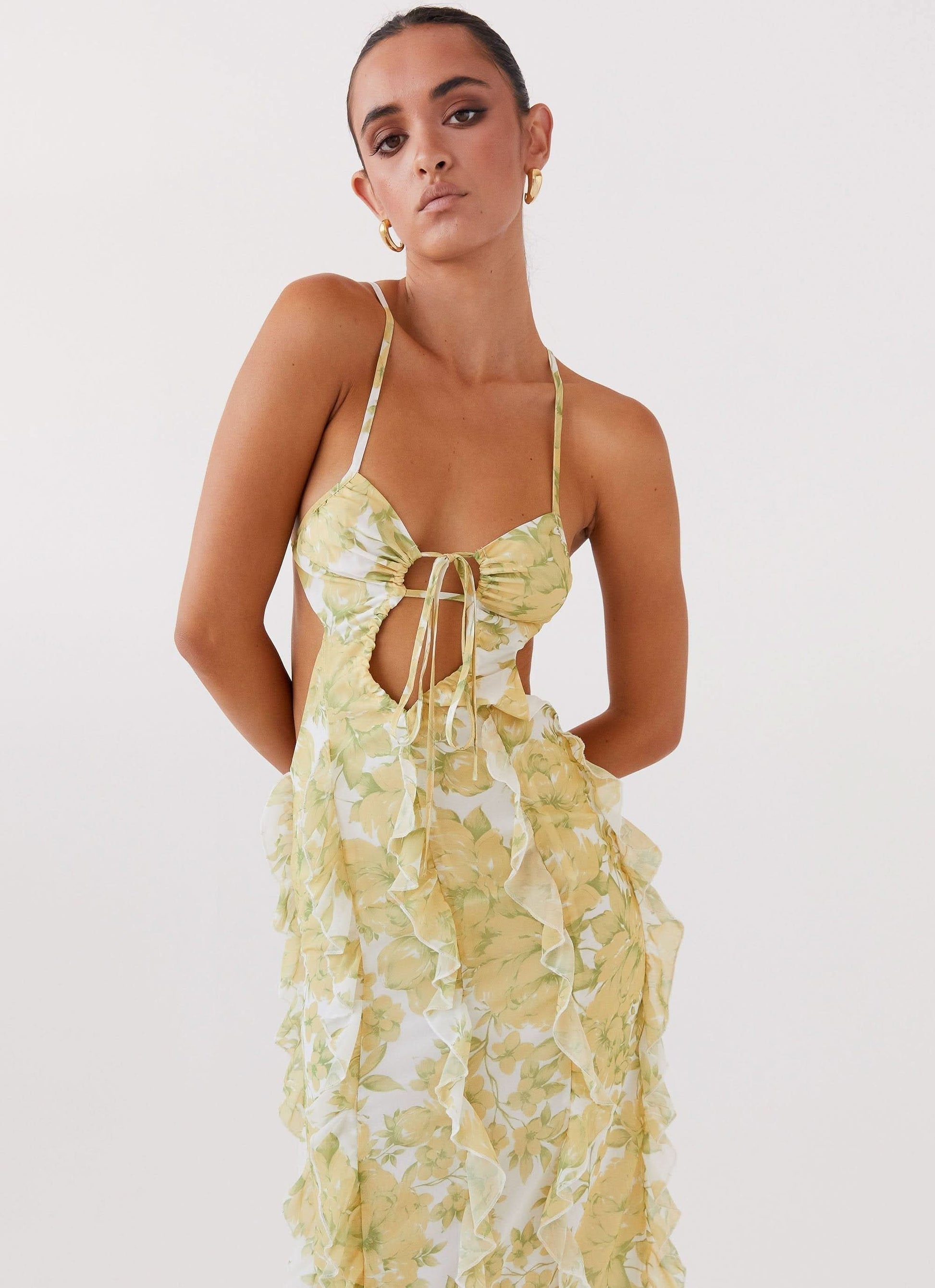 Close-up of floral maxi dress bodice with tie front, cutout detail, and delicate spaghetti straps