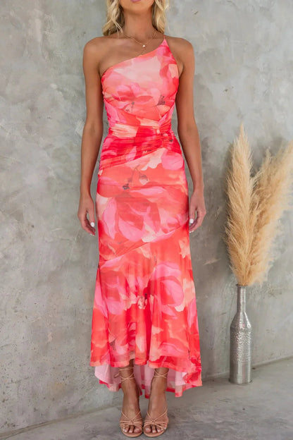Coral pink floral midi dress with one shoulder neckline and flowing high-low skirt