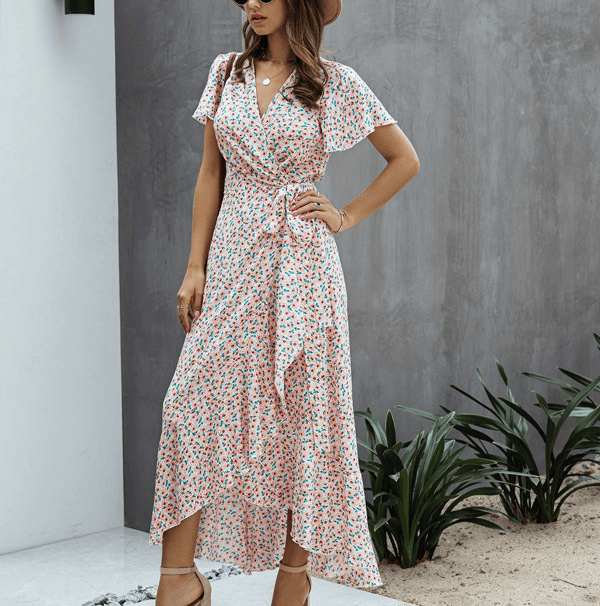 Pink floral wrap midi dress with V neck, flutter sleeves, and side tie detail