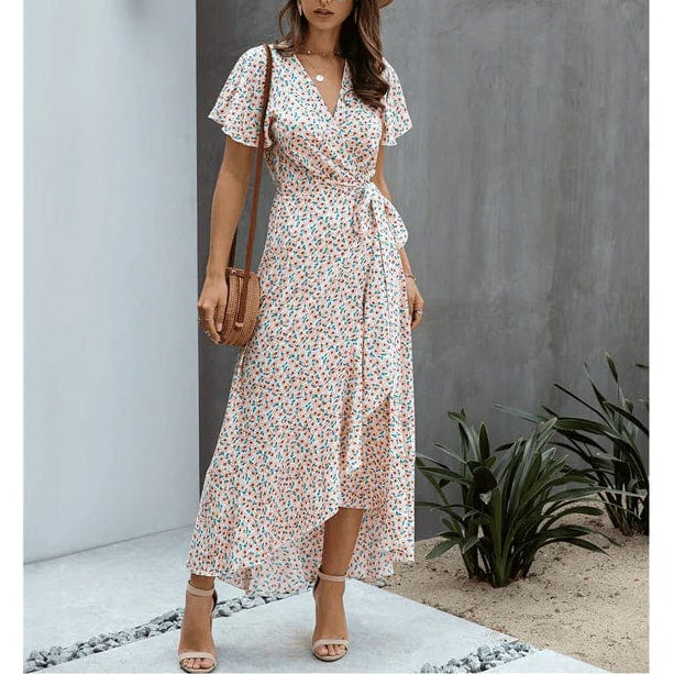 Pink floral V neck midi dress with short flutter sleeves, wrap front, and asymmetrical hem