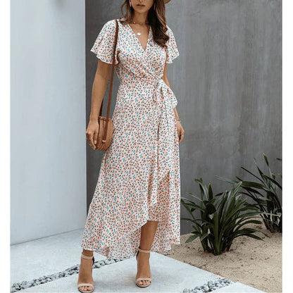 Pink floral V neck midi dress with short flutter sleeves, wrap front, and asymmetrical hem