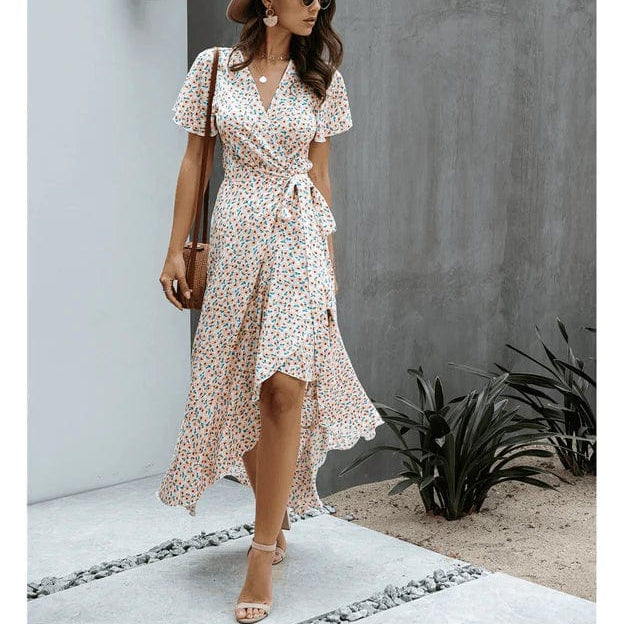 Pink floral wrap midi dress with V neckline, flutter sleeves, and flowing high-low skirt