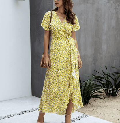 Yellow floral V neck midi dress with flutter sleeves, wrap tie waist, and ruffled hem