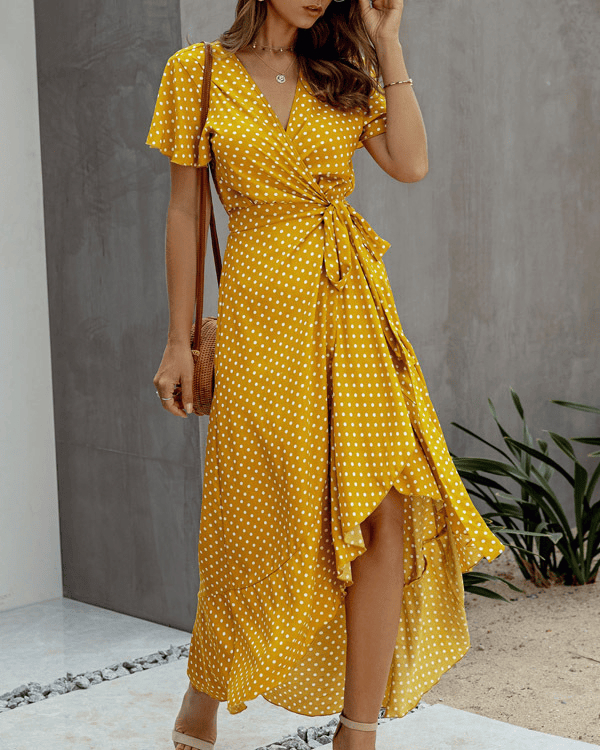 Mustard polka dot midi dress with V neck, flutter sleeves, wrap waist, and front slit