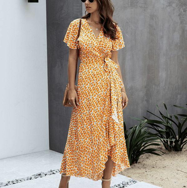 Orange floral wrap midi dress with V neck, flutter sleeves, and side tie detail