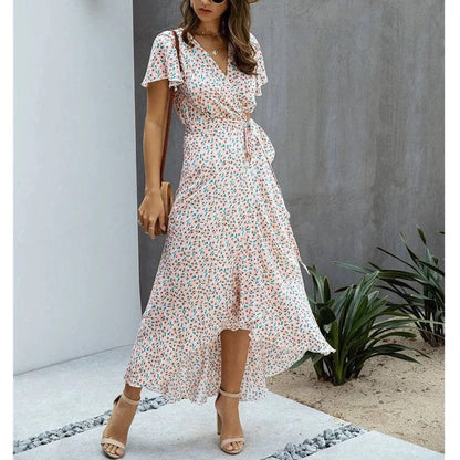 Pink floral V neck midi dress with flutter sleeves, wrap waist tie, and high-low hem