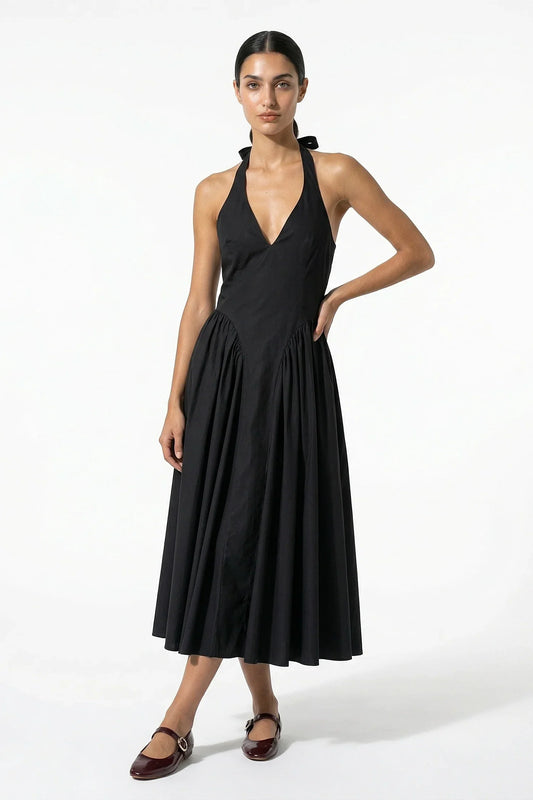 Black halter midi dress with deep V neckline and full pleated skirt, front view