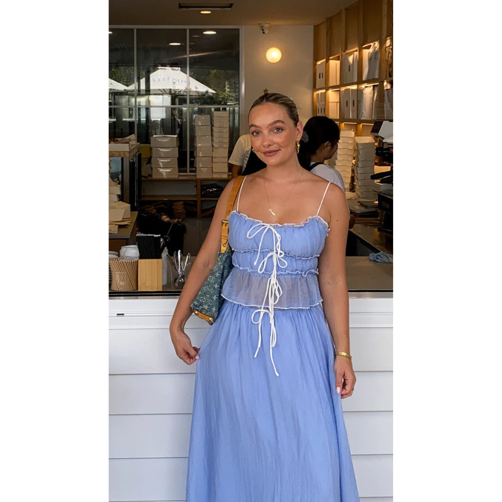 Blue summer maxi skirt set with ruched camisole top and long skirt worn indoors