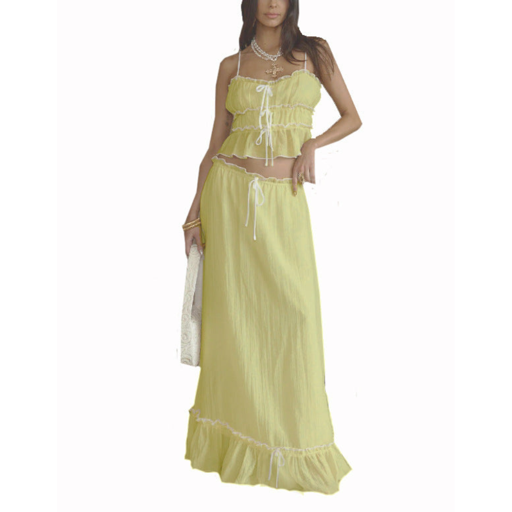 Yellow summer maxi skirt set with ruffled crop top and matching long skirt on white background