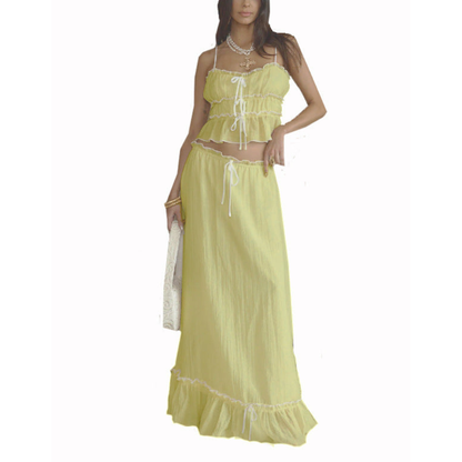 Yellow summer maxi skirt set with ruffled crop top and matching long skirt on white background
