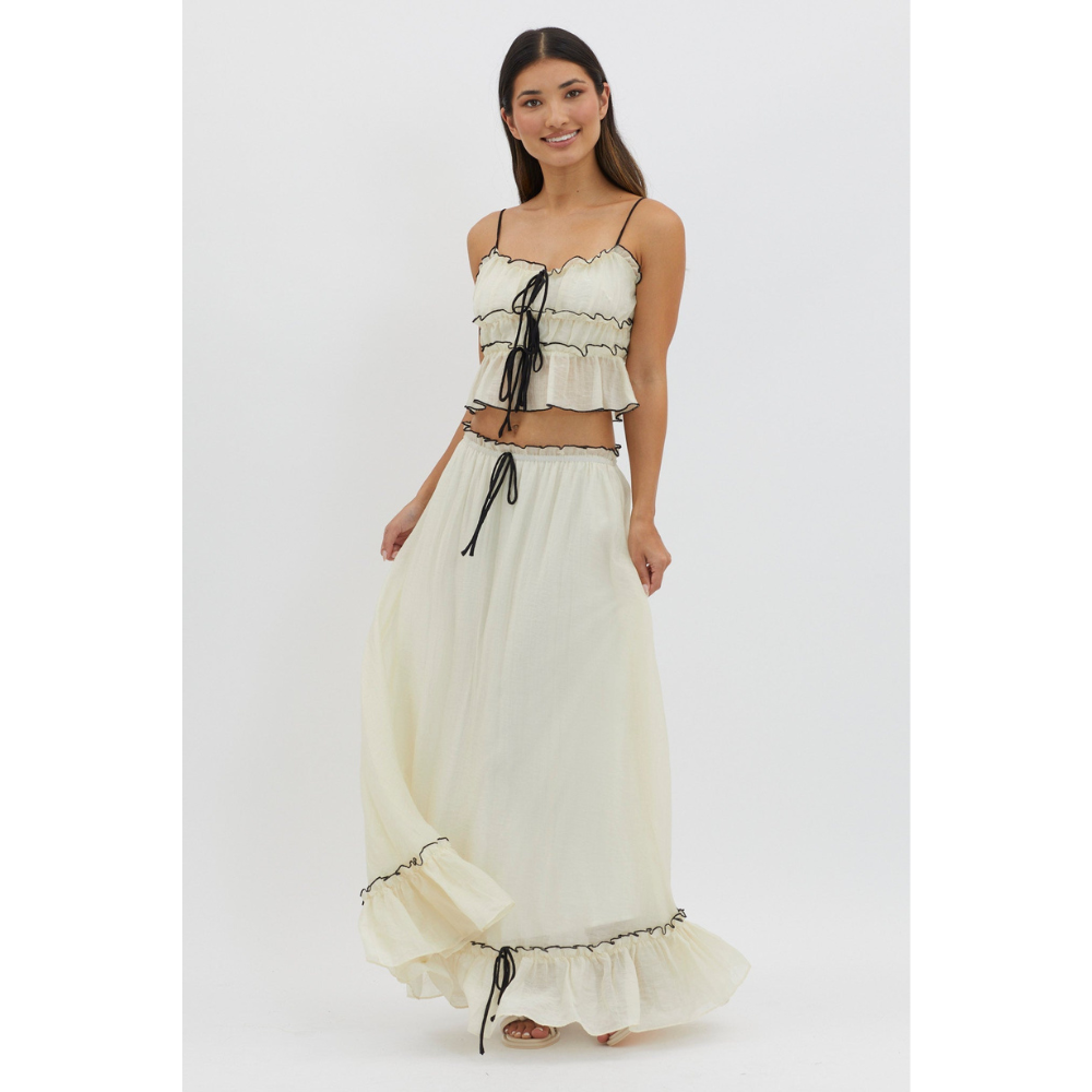 Cream maxi skirt set with black trim and tie-front crop top, front view on white background