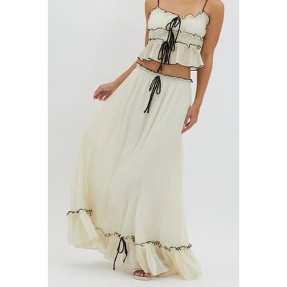 Cream summer maxi skirt set with black trim, close-up of tie-front crop top and flowing skirt