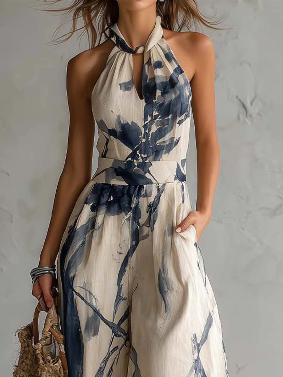 Close-up of halter neckline and waist on cream navy printed jumpsuit, keyhole detail