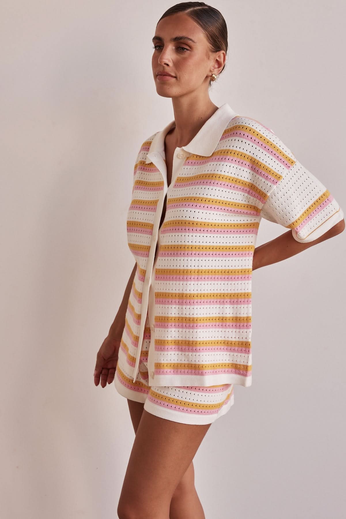 Side view of striped collared knit shirt and matching shorts set for women