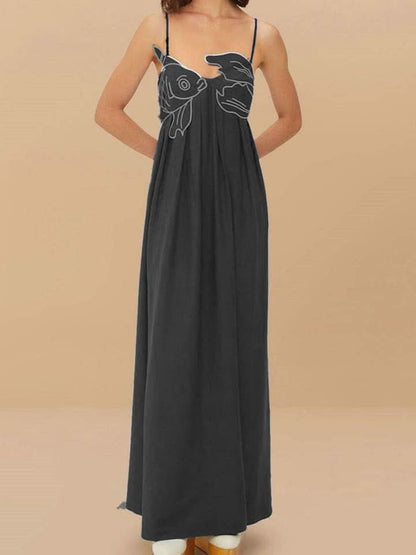 Black fish print maxi dress shown from the back with thin straps and long drape