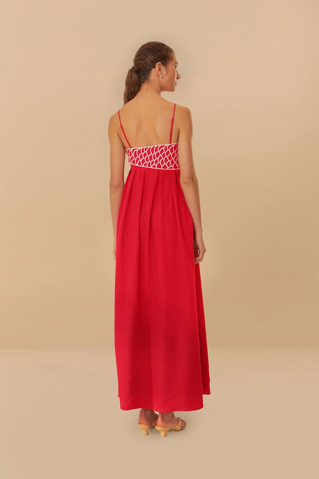 Back view of red fish print maxi dress with open back and scalloped waistband detail