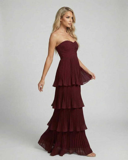 Burgundy strapless maxi dress with sweetheart neckline and layered pleated skirt