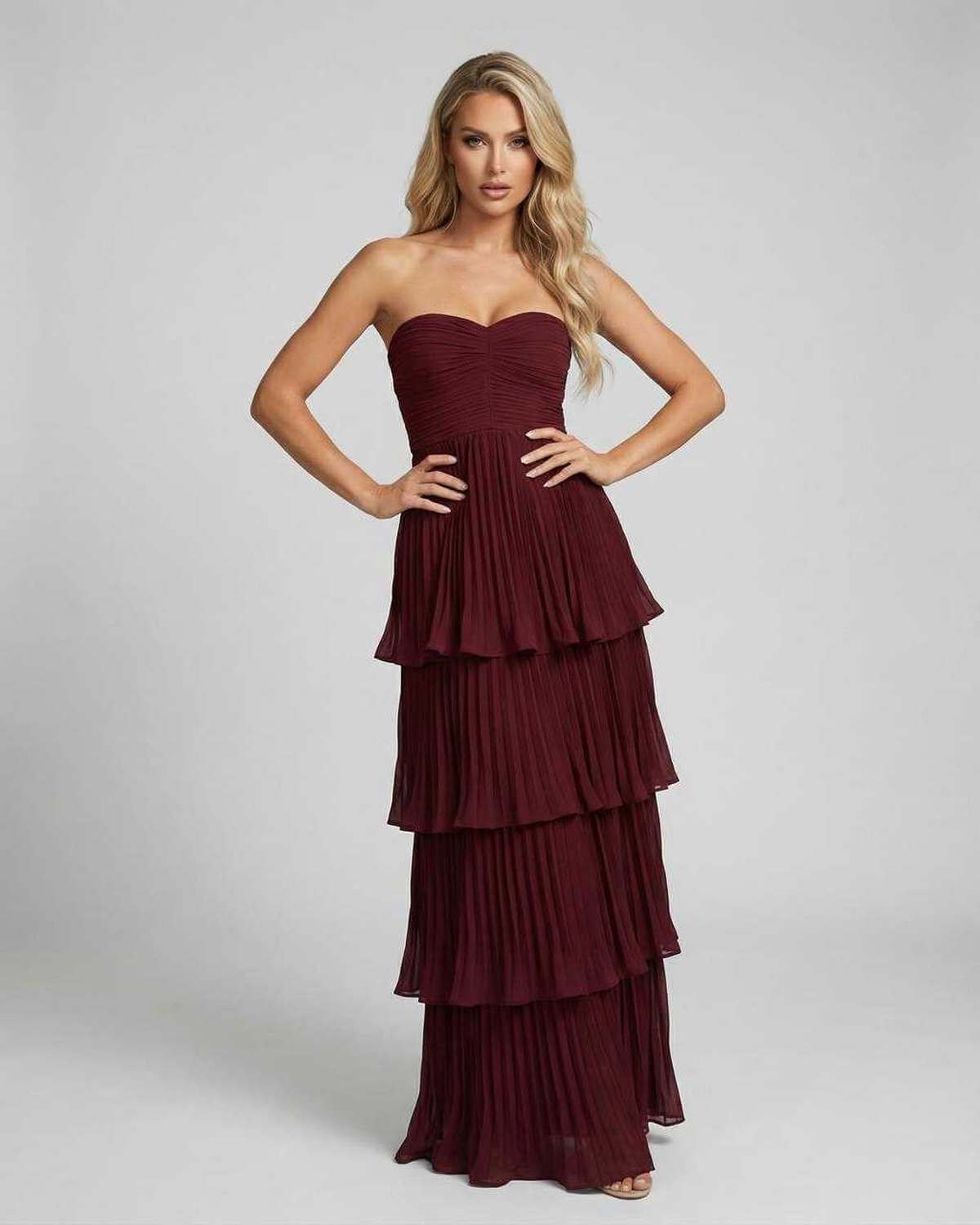 Burgundy strapless maxi dress with tiered pleated skirt for wedding guest