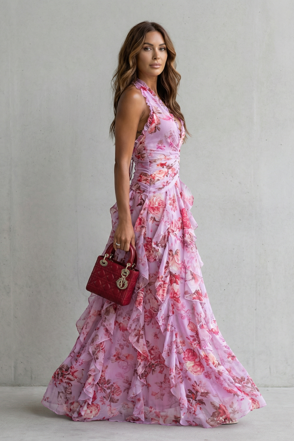 Side view of pink floral halter maxi dress showing fitted bodice and flowing skirt
