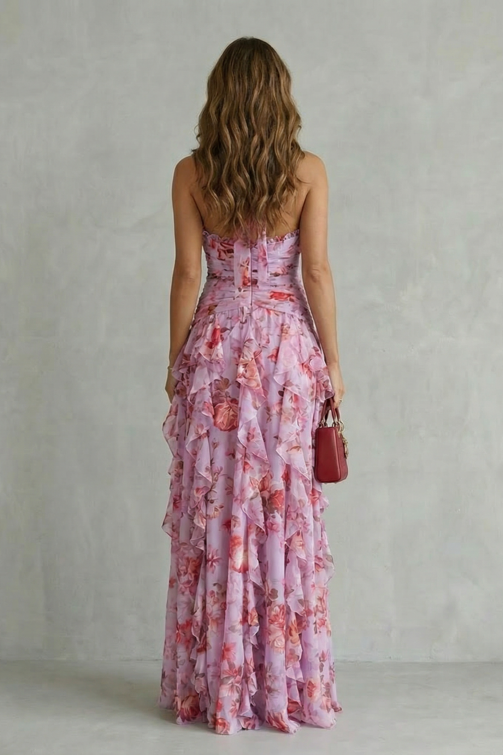 Back view of pink floral halter maxi dress with strapless back and tiered skirt