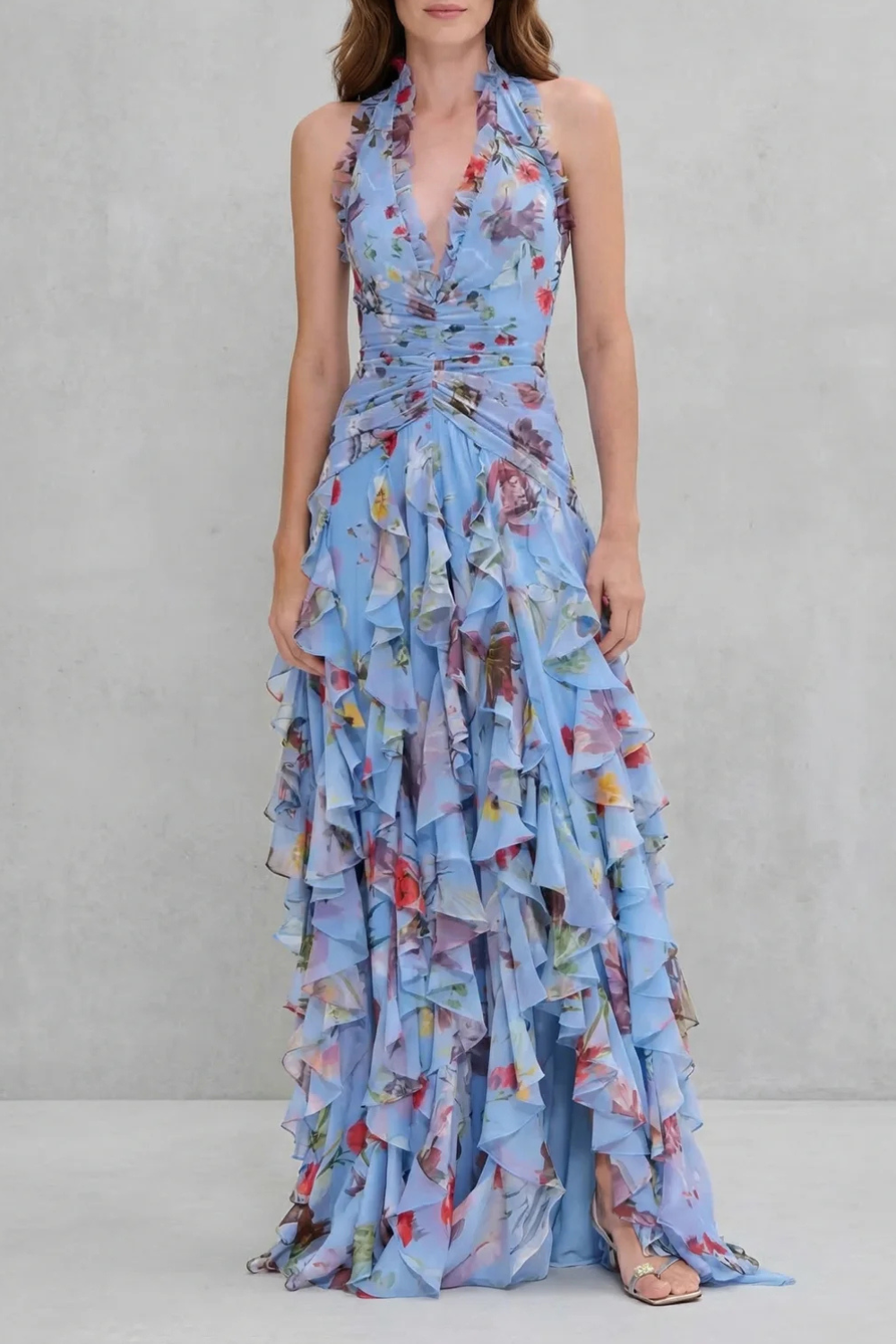 Blue floral halter maxi dress with deep V neckline and cascading ruffle layers