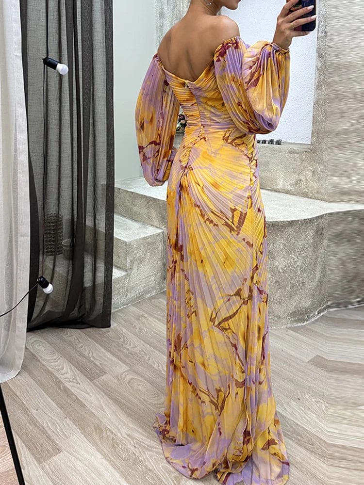 Back view of floral off shoulder maxi dress with long puff sleeves and flowing skirt