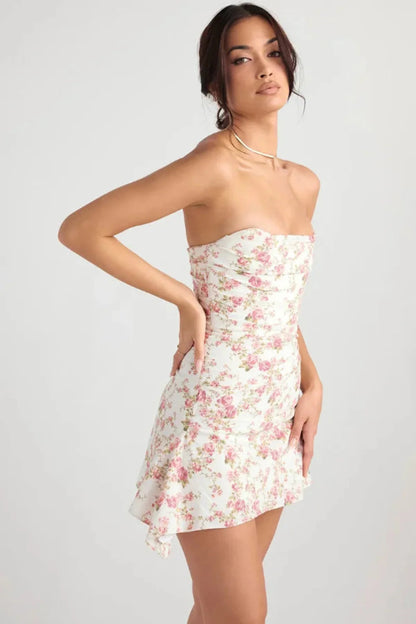 Side back view of a women's wedding guest floral strapless mini dress with fitted waist and flared skirt