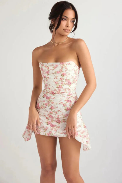 Front angled view of a floral strapless mini dress showing ruched bodice and asymmetrical hem