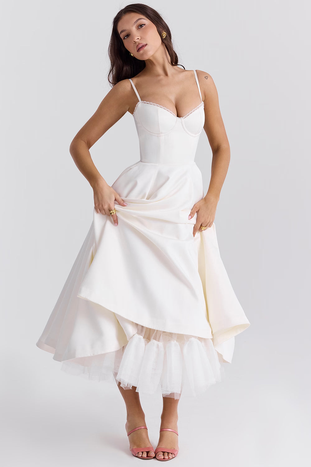 White midi dress with layered skirt and spaghetti straps for wedding guest