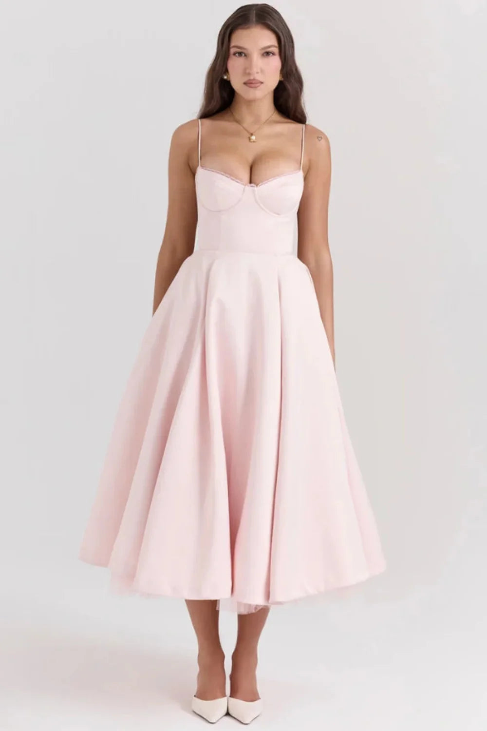 Blush pink midi dress with spaghetti straps and full skirt for wedding guest