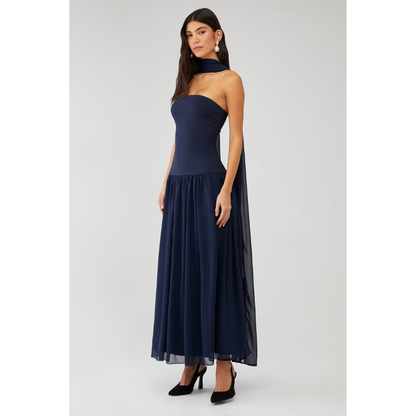 Front angled view of navy strapless maxi dress with flowing chiffon skirt