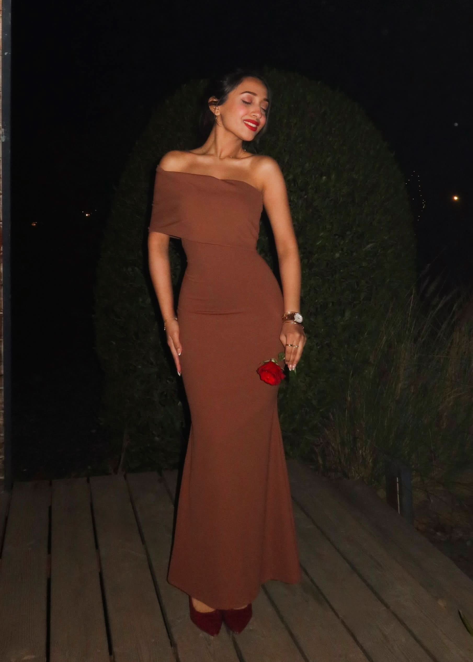 Terracotta wedding guest maxi dress shown from the side with sleek fitted silhouette