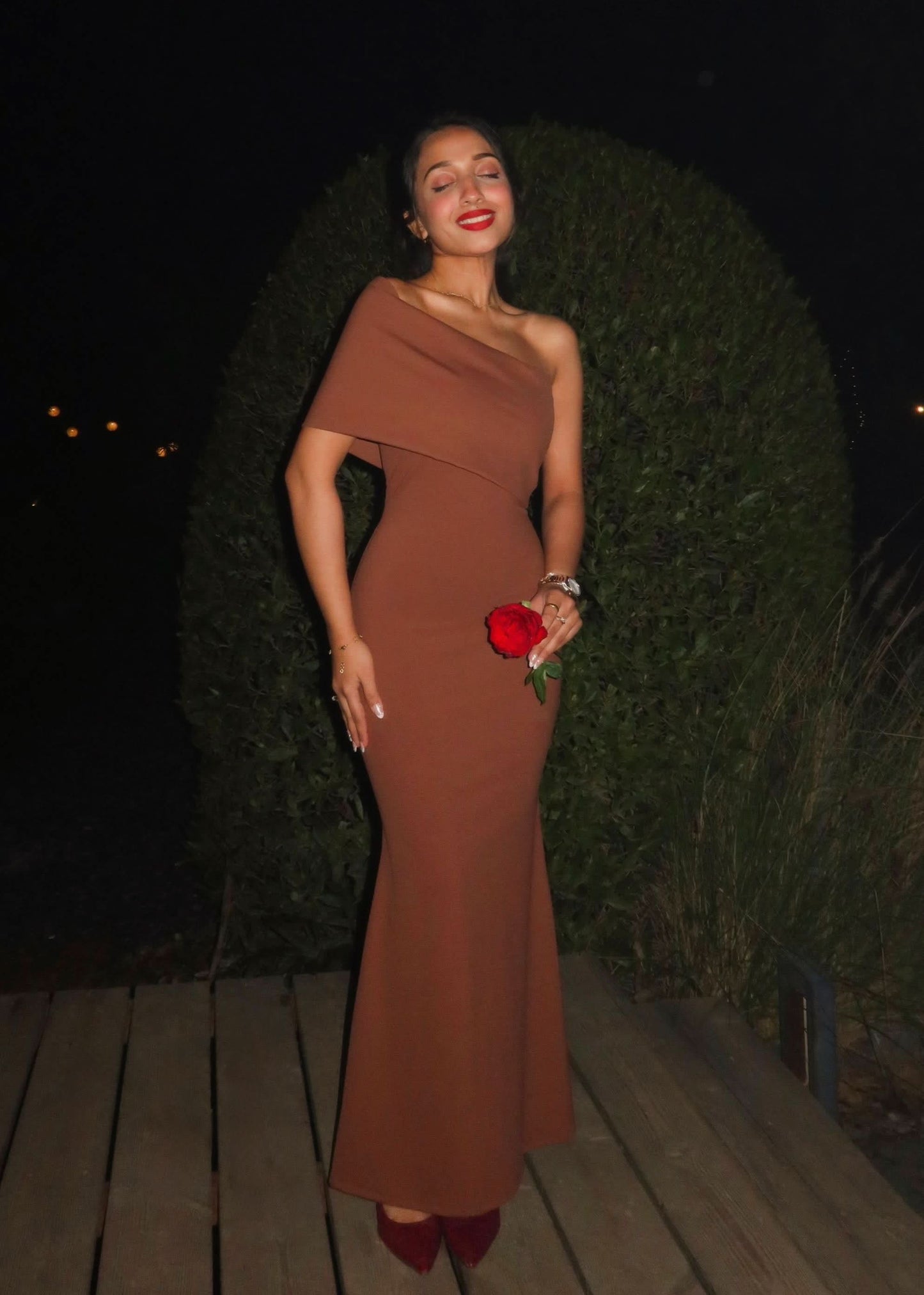 Back view of terracotta wedding guest maxi dress with sleek bodycon fit