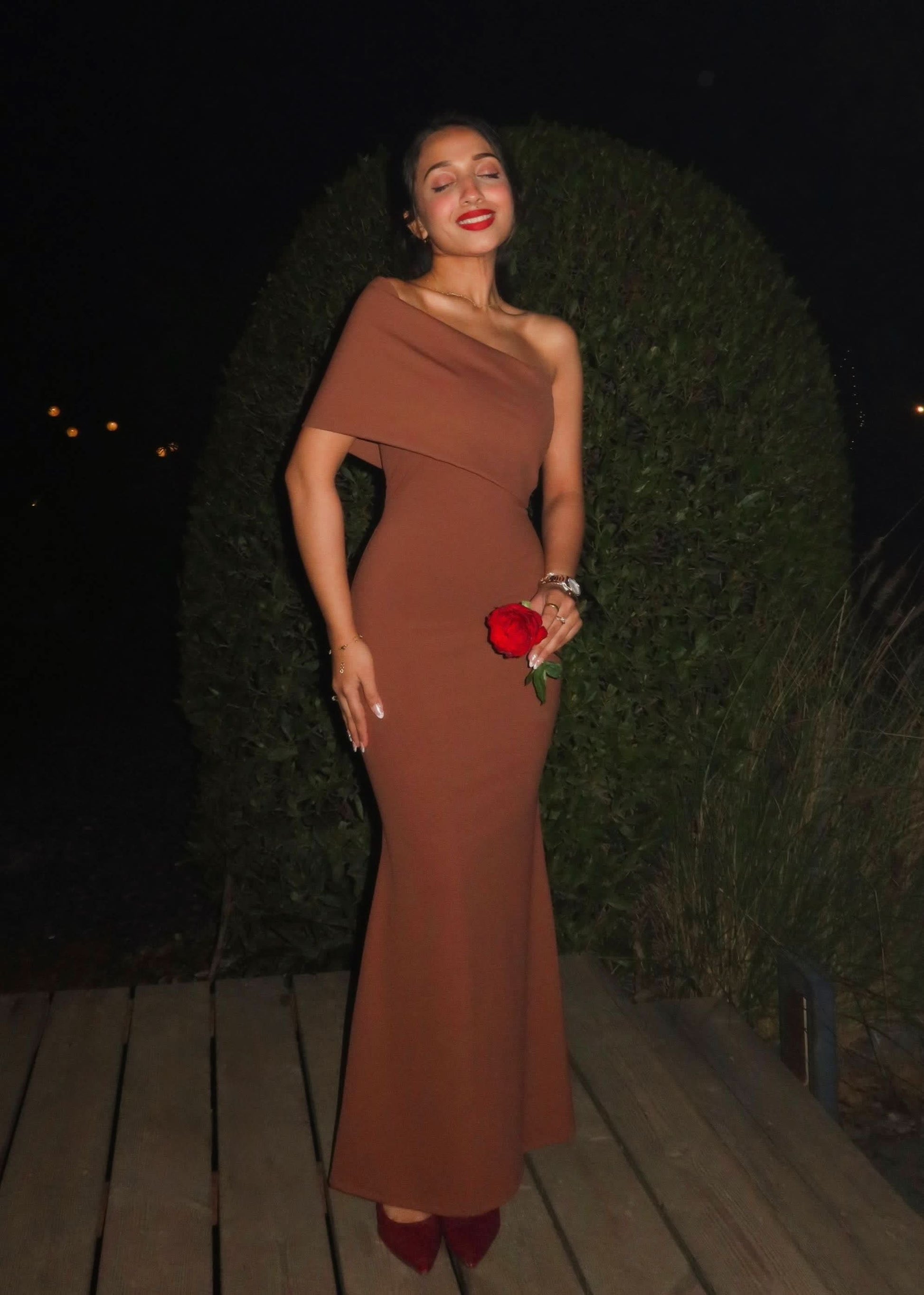 Back view of terracotta wedding guest maxi dress with sleek bodycon fit