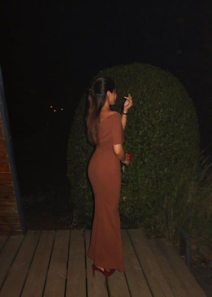 Front pose of terracotta maxi dress with smooth fitted bodice and elegant drape