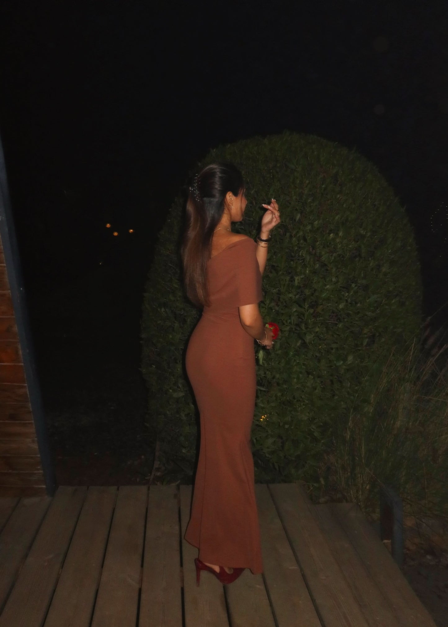 Side back view of terracotta maxi dress with low-back fit and long flowing skirt