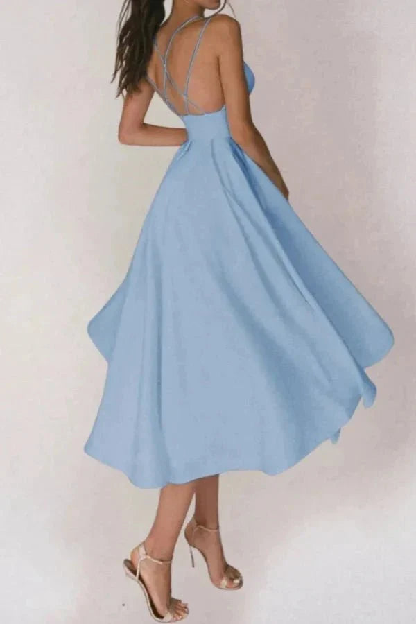 Back view of light blue V neck midi dress with open back and strappy heels