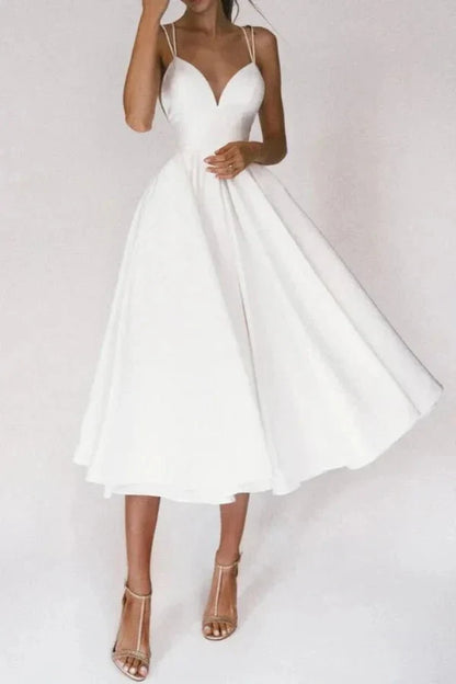 White V neck midi dress with thin straps and flared skirt for wedding guest