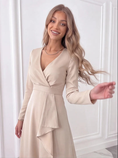 Close-up of beige wrap midi dress showing V-neck bodice, waist tie detail and draped front
